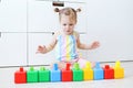 2 years toddler girl playing with multicolored cubes at home Royalty Free Stock Photo