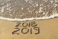 2019, 2018 years written on sandy beach sea. Royalty Free Stock Photo