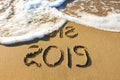 2019, 2018 years written on sandy beach sea. Royalty Free Stock Photo