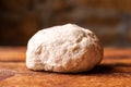 Yeast dough ball on wooden background. Cooked dough for baking pizza or bread