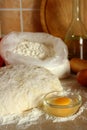 Yeast dough, eggs, and flour on the table.