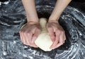 Yeast dough is kneaded by women. Royalty Free Stock Photo