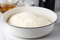 yeast dough rising in a covered bowl Royalty Free Stock Photo