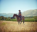 Yeeha. Full-length portrait of a mature man on a horse out in a field. Royalty Free Stock Photo