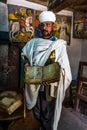Yeha, Ethiopia - Feb 10, 2020: an orthodox priest shows a painted holy bible in the Great Temple of the Moon