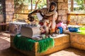 Yeha, Ethiopia - Feb 10, 2020: Young woman in traditional clothing is preparing a coffee ceremony at Temple of the Moon