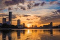 Yekaterinburg city center on sunset. City pond view, amazing clouds and sky. High buildings, skyscrapers on the embankment