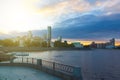 Yekaterinburg city center on sunset. City pond view, amazing clouds and sky. High buildings, skyscrapers on the embankment of the