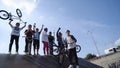 Yekaterinburg, Russia-August, 2019: Team of cyclists on ramp. Action. Cheerful young cyclists exult standing on ramp on
