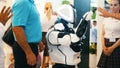 Yekaterinburg, Russia - July, 2019: Close-up of people looking at a black and white moving plastic humanoid robot. Media