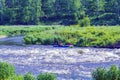 Yekaterinburg, Russia - June 8, 2019: Extreme whitewater rafting trip. A group of people team in kayaks practise traversing the Royalty Free Stock Photo