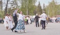 Senior couples dance in park.