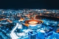 Aerial view of the stadium with night illumination and residential buildings in the Royalty Free Stock Photo