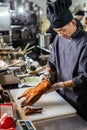 Yekaterinburg, Russia - November 16, 2017: Chinese chef cooking duck at the kitchen of chinese restaurant