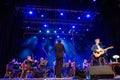 Concert of american musician David Arthur Brown and symphony orchestra under bright scenic spotlights