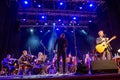 Concert of american musician David Arthur Brown and symphony orchestra under bright scenic spotlights