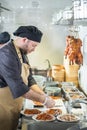 Yekaterinburg, Russia - November 16, 2017: white male chef cooking duck at the kitchen of chinese restaurant