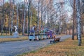 Yekaterinburg, Russia An almost empty colorful children`s amusement train riding along the alley of the city park in late autumn