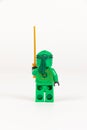 Toy hero Lloyd in a green kimono with a sword from a set of Lego ninjago on a white background Royalty Free Stock Photo