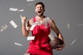 Basketball player with ball Isolated On grey with falling money