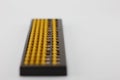 Yellow abacus Is plastic placed on a white background