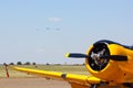 Yellow Aerobatic Aircraft With Formation On Approach