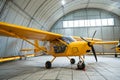 Yellow airplane glider in the hangar. Royalty Free Stock Photo
