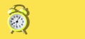 Yellow Alarm Clock on Yellow Background in Banner size Royalty Free Stock Photo