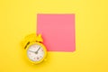 Yellow alarm clock and colorful sticky notes on a yellow background. The concept of working time. Workplace Royalty Free Stock Photo