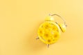 Yellow alarm clock with daisies instead of a dial. Royalty Free Stock Photo