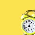 Yellow Alarm Clock at Eight in the Morning on Yellow Background in Square size Royalty Free Stock Photo