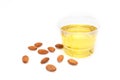 Yellow almond oil in a clear bowl.