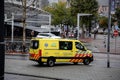 Yellow ambulance car with medical signs and 112 emergency call number on the street in Rotterdam, the Netherlands