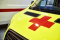 Yellow ambulance car with red cross