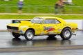 Yellow American muscle car on a drag strip Royalty Free Stock Photo