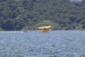 Yellow amphibious seaplane taking off from Lake Casitas, Ojai, California