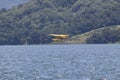 Yellow amphibious seaplane taking off from Lake Casitas, Ojai, California