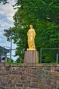 Yellow antique monument of a woman in tunic, Vyborg, Russia