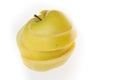 Yellow apple cut into slices over white background Royalty Free Stock Photo