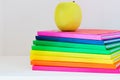 A yellow apple sitting on top of a stack of school books Royalty Free Stock Photo