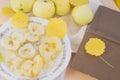 Yellow apples and baked apples lie on a plate near an open book in autumn with autumn leaves Royalty Free Stock Photo