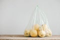 Yellow apples in a plastic bag on a wooden table. Copy, empty space for text Royalty Free Stock Photo