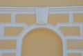 Yellow architectural element vault in the wall. The white arch is an imitation of a window. Renovated building Royalty Free Stock Photo