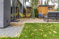 Yellow armchairs and grey sofas in the garden