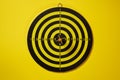 Yellow arrow dart hitting the center of the target dartboard Royalty Free Stock Photo