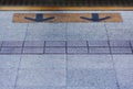 Yellow arrow sign on floor at train platform, subway station Royalty Free Stock Photo