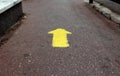 Yellow arrow sign on gray asphalt road showing direction forward Royalty Free Stock Photo