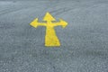 A yellow arrow sign for turn left and right on the asphalt road, concept of direction and direction Royalty Free Stock Photo