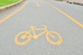 Yellow arrows and bicycle sign path