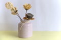 Yellow artificial flowers and lotus root in ceramic vases. Indoor decorations